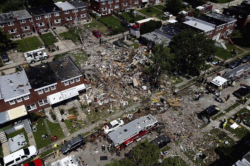 Debris and rubble covers the ground in the aftermath of an explosion in Baltimore on Monday, Aug. 10, 2020. Baltimore firefighters say an explosion has leveled several homes in the city. (AP Photo/Julio Cortez)