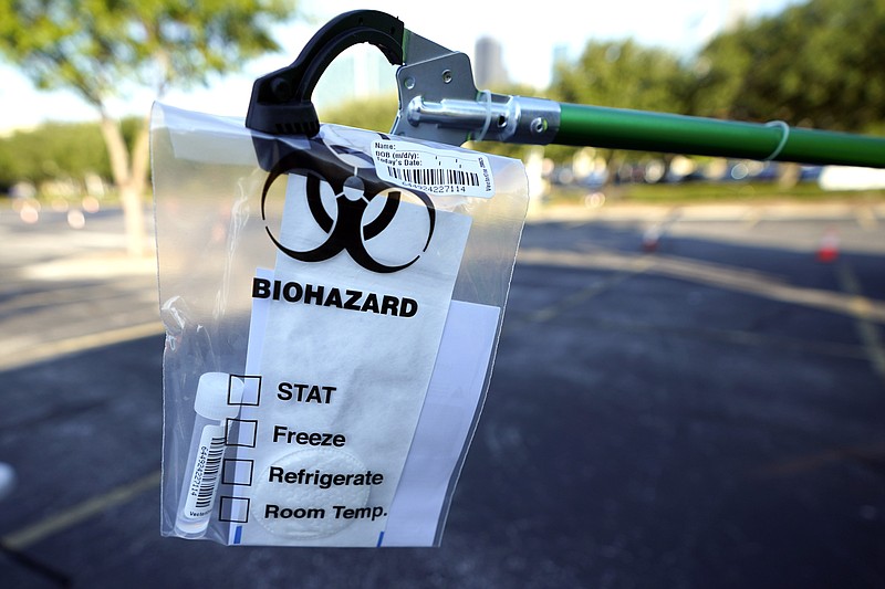 A test kit is displayed at a Texas Division of Emergency Management free COVID-19 testing site at Minute Maid Park Saturday, Aug. 8, 2020, in Houston. The newly opened mega site, which has eight drive-thru lanes and four walk-up lanes, has the ability to process 2,000 tests per day. (AP Photo/David J. Phillip)