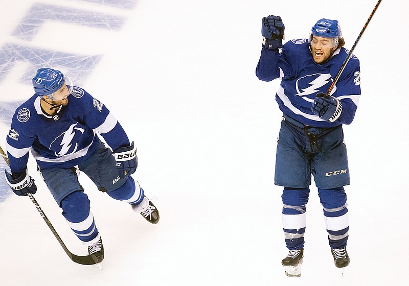 Brayden Point of the Lightning (right) celebrates his game-winning goal with teammate Kevin Shattenkirk during the fifth overtime in Game 1 of a Stanley Cup first-round playoff series Tuesday against the Blue Jackets in Toronto.