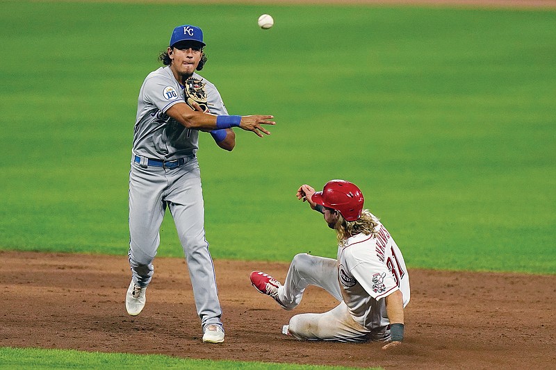 Royals second baseman Nicky Lopez throws to first around a sliding Travis Jankowski of the Reds to complete a double play during Tuesday night's game in Cincinnati.