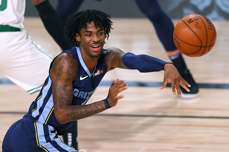 Ja Morant of the Grizzlies passes the ball during Tuesday night's game against the Celtics in Lake Buena Vista, Fla.