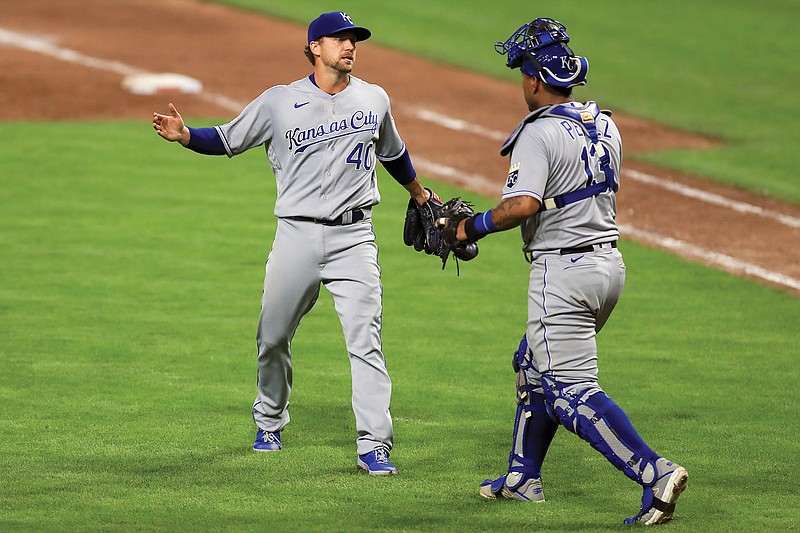 Royals reliever Trevor Rosenthal celebrates with catcher Salvador Perez after Wednesday night's 5-4 win against the Reds in Cincinnati.