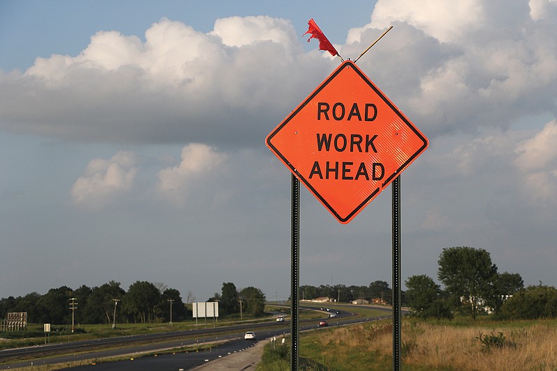 A sign cautions road work ahead Thursday, Aug. 13, 2020, along the side of an on-ramp merging onto U.S. 54. (News Tribune photo)