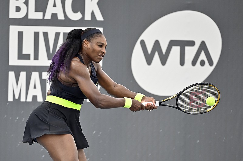 Serena Williams returns a shot to her sister Venus Williams during the WTA tournament Thursday in Nicholasville, Ky.