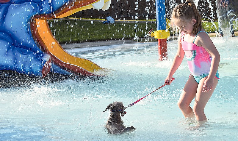 Annabelle Hoose, 6, persuades her hesitant dog, Apple, to enter the children's area at Memorial Park Family Aquatic Center's Hot Dippity Dog event Sunday, Aug. 16, 2020.