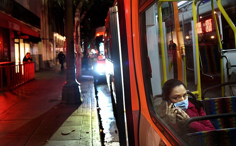 A passenger wears a mask on a Metro bus on March 26, 2020, during a coronavirus outbreak in downtown Los Angeles.