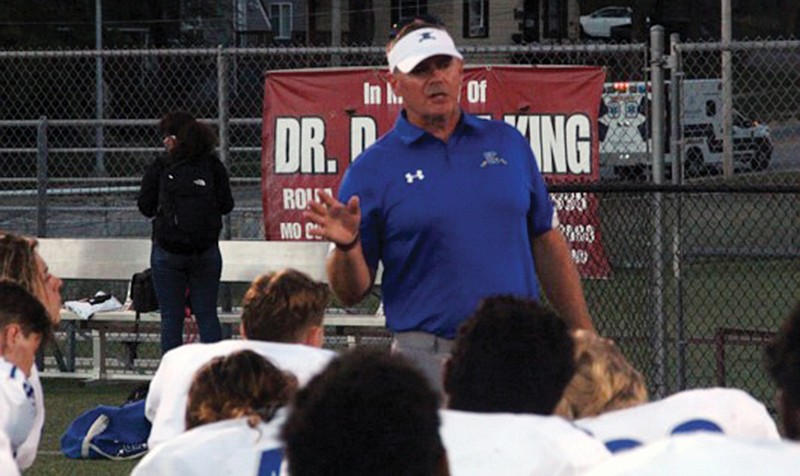 Capital City coach Shannon Jolley talks to the Cavaliers following last Friday night's Jamboree against Rolla in Rolla.