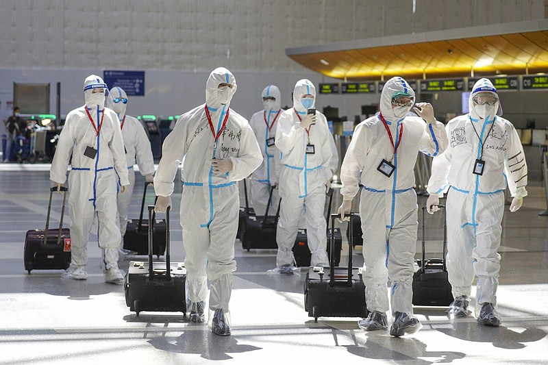 A flight crew in full biohazard suits at Tom Bradley International Terminal at LAX on Friday, May 22, 2020 in Los Angeles, Calif. Qian Lang, the first confirmed case of COVID-19 in Los Angeles, remained the sole patient diagnosed with the virus here for five weeks, passing most of that time in top-secret isolation at Cedars-Sinai Medical Center. (Irfan Khan/Los Angeles Times/TNS)