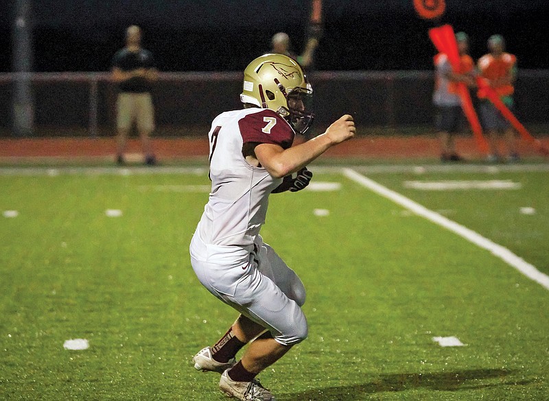 Owen Levesque of Eldon takes off with the football during a game last season against Blair Oaks at the Falcon Athletic Complex in Wardsville.