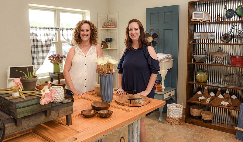 Julie Smith/News Tribune
Tricia Smith, left, and Shana Luebbering pose for a photo inside their shop at 1502 E. McCarty St. Thursday. The pair is gearing up to open a gift shop called Honey Do Boutique in that location in September.