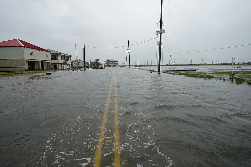 Water flows down a flooded street Friday, Aug. 28, 2020, in Cameron, La., after Hurricane Laura moved through the area Thursday. (AP Photo/David J. Phillip)