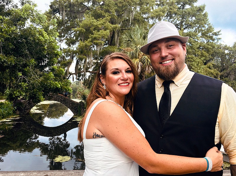 This image released bu Jordan Tyler shows Tyler, right, with his wife Brittany in New Orleans on July 18, 2020. The couple signed up for Match.com, started texting March 18 and were wed by July. (Jordan Tyler via AP)