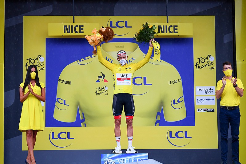 Alexander Kristoff of Norway wearing the overall leader's yellow jersey celebrates on the podium after the first stage of the Tour de France cycling race over 156 kilometers (97 miles) with start and finish in Nice, southern France, Saturday, Aug. 29, 2020. (Stuart Franklin/Pool via AP)