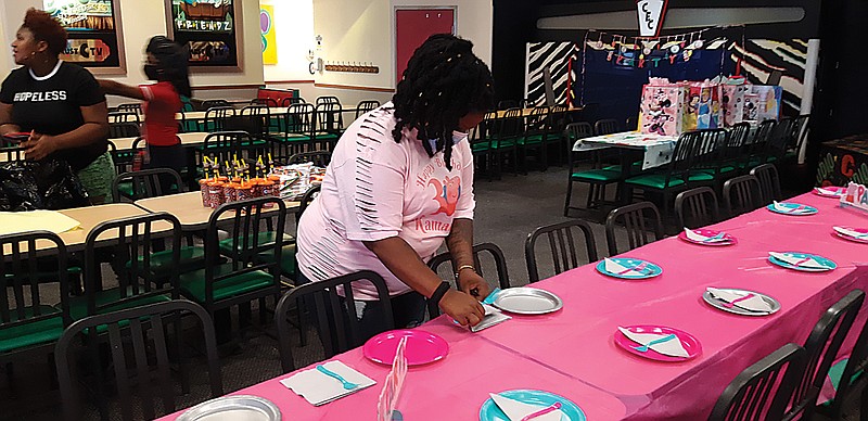 The Saturday staff of Chuck E. Cheese prepares their dining area for a birthday party. A favorite location for kids' celebrations, their dining area and amusement facilities have been off-limits because of COVID restrictions.