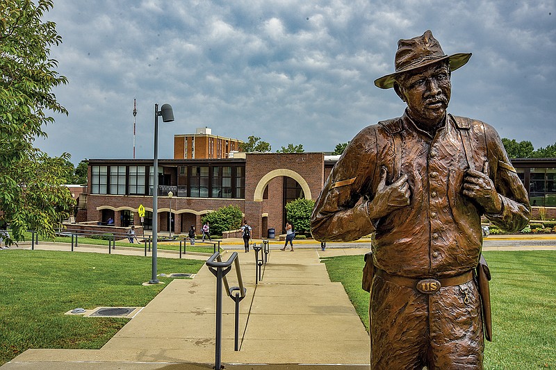 Students pass by the Civil War Memorial on Monday during class changes at Lincoln University. Lincoln has been holding in-person classes for one week.