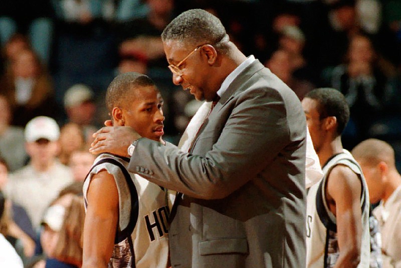 In this Jan. 24, 1996, file photo, Georgetown head coach John Thompson talks to Allen Iverson during an NCAA college basketball game against St. John's, in Landover, Md. Thompson, the imposing Hall of Famer who turned Georgetown into a basketball powerhouse and became the first Black coach to lead a team to the NCAA men's title, has died at age 78, his family announced through the university, Monday, Aug. 31, 2020. (Porter Binks/USA Today via AP, File)