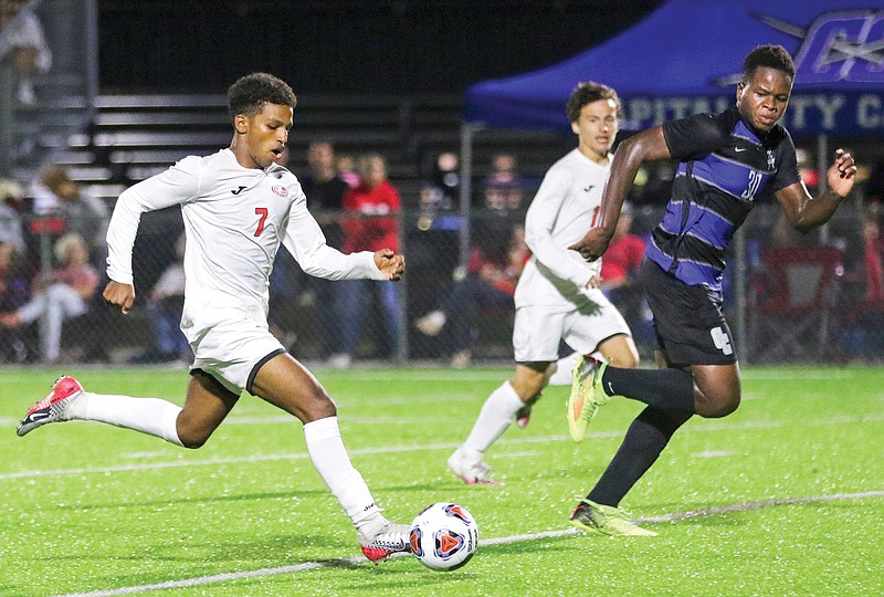 Jefferson City's Bassil Ahmed (left) bolts toward the goal as Capital City's Mark Eckekwu defends during Tuesday's game at Capital City.