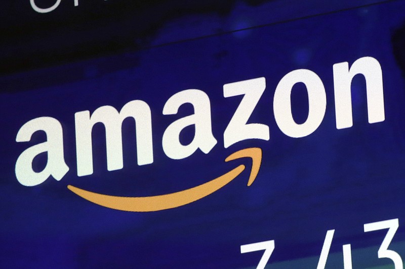 FILE - In this Friday, July 27, 2018 file photo, the logo for Amazon is displayed on a screen at the Nasdaq MarketSite.  E-commerce giant Amazon has announced Thursday Sept. 3, 2020, it is adding 7,000 more permanent jobs in the U.K. by the end of the year, in the latest sign that demand for online shopping and services is booming amid the pandemic.  (AP Photo/Richard Drew, file)
