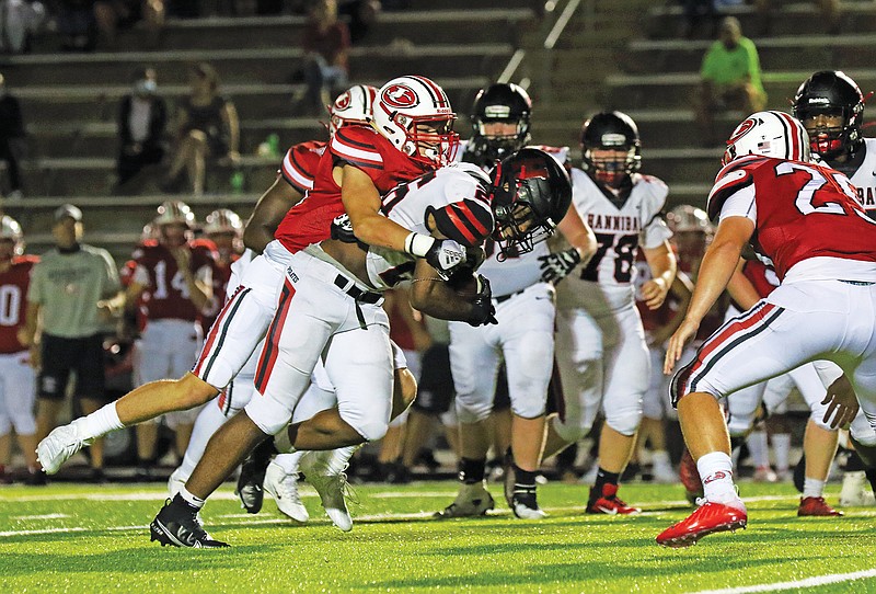 Jason Strickland/News Tribune
Jefferson City's Ethan Garnett wraps up Hannibal running back Damien French during Friday night's game at Adkins Stadium. 