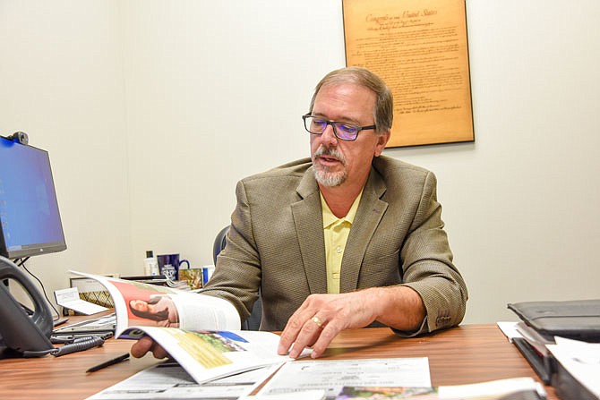 In this September 2020 photo, Lyndall Fraker, director of the Medical Marijuana Division of the Department of Health and Senior Services, refers to an industry magazine for information while seated for an interview regarding the status of the medical marijuana roll out in Missouri.