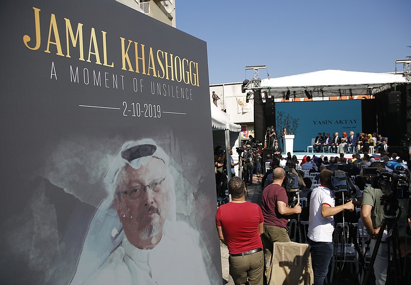 FILE - In this Oct. 2, 2019 file photo, a picture of slain Saudi journalist Jamal Kashoggi, is displayed during a ceremony near the Saudi Arabia consulate in Istanbul, marking the one-year anniversary of his death. Saudi Arabia’s state television says final verdicts have been issued in the case of slain Washington Post columnist and Saudi critic Jamal Khashoggi after his family announced pardons that spared five from execution. The Riyadh Criminal Court issued final verdicts Monday, Sept. 7, 2020, against eight people. The court ordered a maximum sentence of 20 years in prison for five, with one receiving a 10-year sentence and two others being ordered to serve seven years in prison. The trial was widely criticized by rights groups and an independent U.N. investigator, who noted that no senior officials nor anyone suspected of ordering the killing was found guilty. (AP Photo/Lefteris Pitarakis, File)
