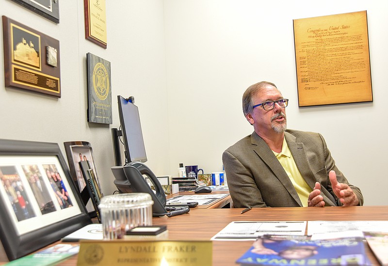 Lyndall Fraker, director of the Medical Marijuana Division of the Department of Health and Senior Services, refers to an industry magazine for information while seated for an interview regarding the current status of the medical marijuana roll out.