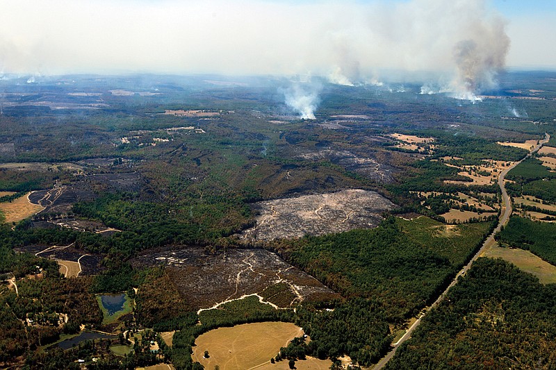 Acres of wildfires smolder in Cass County, with clouds of smoke from the Bear Creek Fire visible for miles.  (Staff file photo by Evan Lewis)
