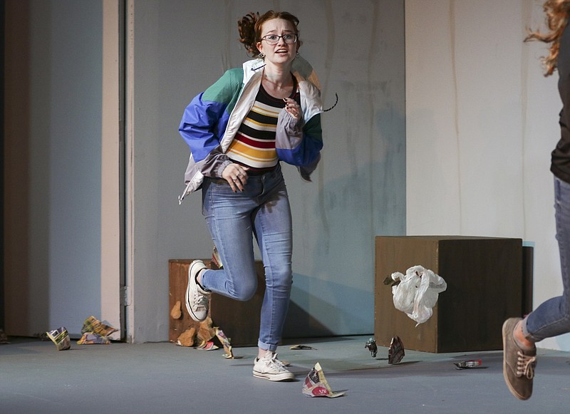 <p>Liv Paggiarino/News Tribune</p><p>Molly Wolken, playing Jill, runs across the stage for the opening scene during the Sept. 1 rehearsal of the upcoming production of “God in the Machine” at Stained Glass Theatre in Jefferson City. The first scene of the play involves a wind machine as the characters find themselves escaping a storm.</p>