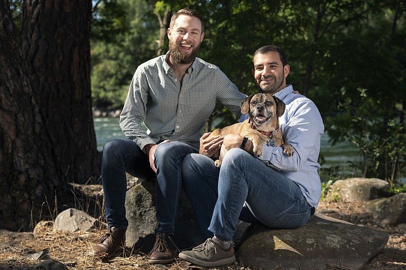 Joshua Waddle, left, and Hamid Habibi share family time with Dexter on his last day before crossing the Rainbow Bridge. (Angela Schneider/The Spokesman-Review/TNS)