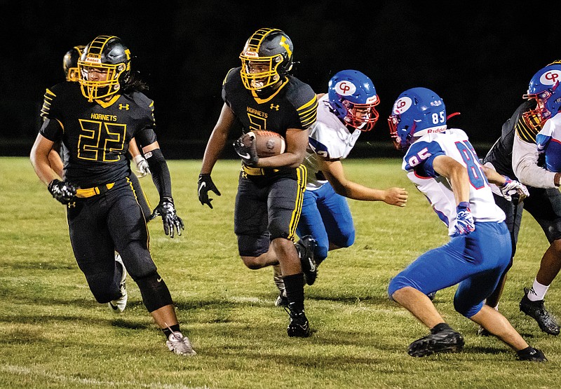 Fulton running back Tyreion Logan follows a block by Davonte Eston during last Friday night's game against California at Robert E. Fisher Stadium in Fulton.