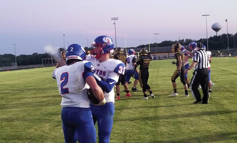 Tagen Higgins and Trevor Myers celebrate after Higgins scored a touchdown during last Friday night's game at Fulton.