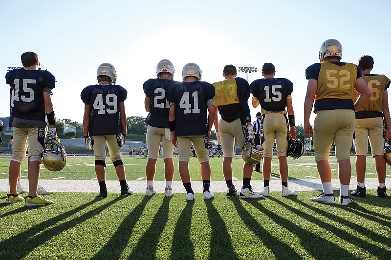 Helias players watch a preseason scrimmage from the sideline last month at Ray Hentges Stadium.
