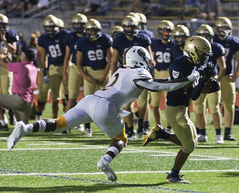 Helias running back Ryan Klahr escapes the grasp of Battle's Gerry Marteen Jr. and runs to score a touchdown during Friday's game at Ray Hentges Stadium.