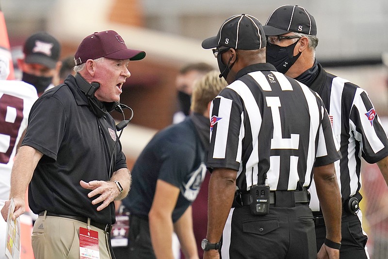 Missouri State coach Bobby Petrino talks with officials in the first half of Saturday's game against Oklahoma in Norman, Okla.