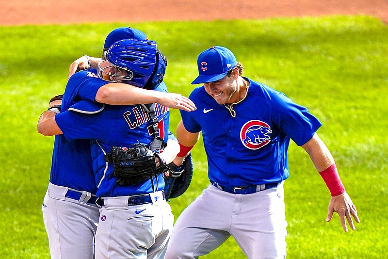 Chicago Cubs starting pitcher Alec Mills is congratulated by teammates catcher Victor Caratini and Anthony Rizzo after throwing a no hitter at a baseball game against the Milwaukee Brewers Sunday, Sept. 13, 2020, in Milwaukee. The Cubs won 12-0. (AP Photo/Morry Gash)