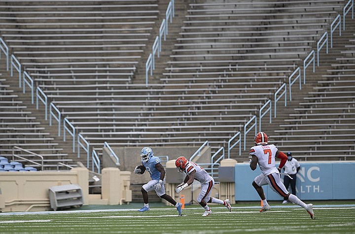 North Carolina's Michael Carter breaks away from Syracuse's Geoff Cantin-Arku in the second quarter of an NCAA college football game Saturday, Sept. 12, 2020 in Chapel Hill, N.C. (Robert Willett/The News & Observer via AP, Pool)