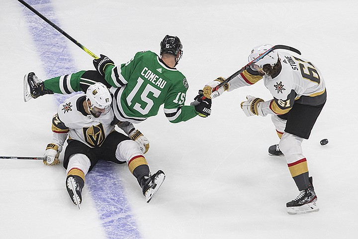 Dallas Stars' Blake Comeau (15) falls over Vegas Golden Knights' Max Pacioretty (67) as he grabs for Knights right wing Mark Stone's stick during the third period of Game 4 of the NHL hockey Western Conference final, Saturday, Sept. 12, 2020, in Edmonton, Alberta. (Jason Franson/The Canadian Press via AP)
