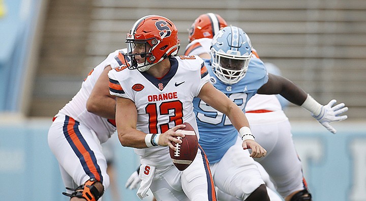 Syracuse quarterback Tommy DeVito (13) scrambles to avoid North Carolina defender Jahlil Taylor (52) in first half of an NCAA college football game, Saturday, Sept. 12, 2020 in Chapel Hill, N.C.(Robert Willett/The News & Observer via AP, Pool)