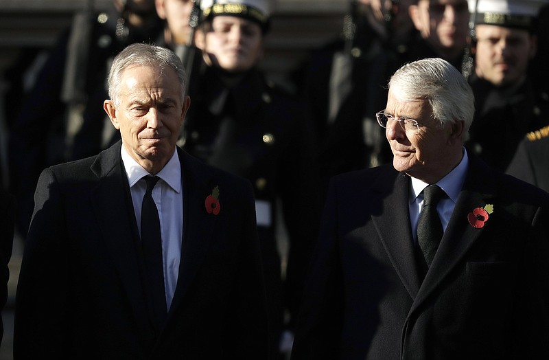 FILE - In this Sunday, Nov. 10, 2019 file photo, former British Prime Ministers Tony Blair, left and John Major attend the Remembrance Sunday ceremony at the Cenotaph in Whitehall in London. Remembrance Sunday is held each year to commemorate the service men and women who fought in past military conflicts. The two former British prime ministers who played crucial roles in bringing peace to Northern Ireland joined forces Sunday, Sept. 13, 2020 to urge lawmakers to reject government plans to over-ride the Brexit deal with the European Union, arguing that it imperils that peace as well as damaging the U.K.’s reputation.  (AP Photo/Matt Dunham, File)