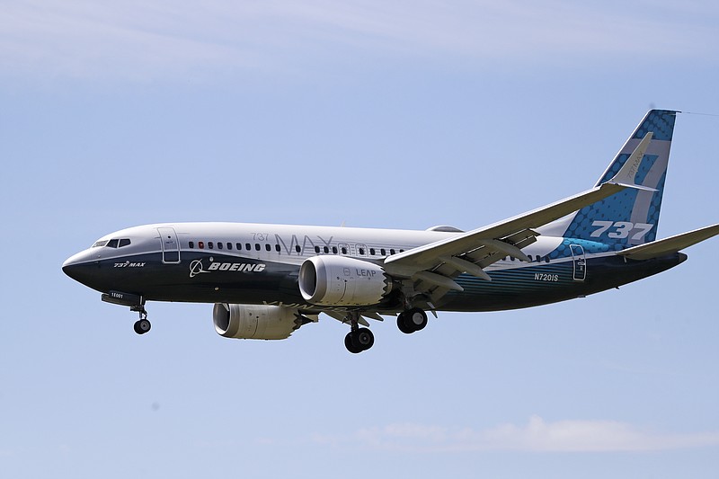 FILE - In this June 29, 2020, file photo, a Boeing 737 Max jet heads to a landing at Boeing Field following a test flight in Seattle. Aviation regulators and pilots from several countries will begin next week reviewing Boeing’s proposal for training pilots to fly the revamped 737 Max, a sign that the grounded plane is moving closer to returning to service. The Federal Aviation Administration said Friday, Sept. 11, 2020, that the review will start Monday at London’s Gatwick Airport and last about nine days. (AP Photo/Elaine Thompson, File)