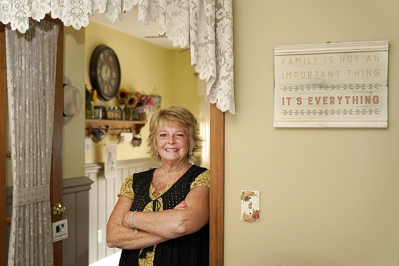 Kay Orzechowicz poses Wednesday, Sept. 2, 2020, for a portrait at her Griffith, Ind., home. After 35 years of teaching, Orzechowicz said COVID-19 "pushed her over the edge" to retire from northwest Indiana's Griffith High School at the end of July. Turning 58 in October, Orzechowicz had hoped to keep teaching for a few more years before retiring from the classroom. But after the pandemic intensified in March, the English teacher said her concerns about holding out mounted. (AP Photo/Charles Rex Arbogast)