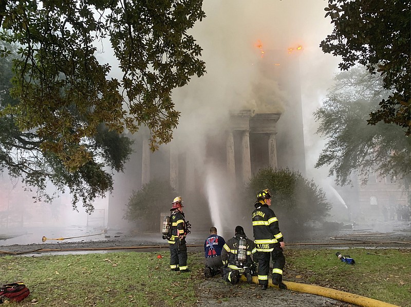This photo provided by Columbia Fire Department, firefighters battle a blaze at Babcock Building in Columbia, S.C., on Saturday, Sept. 12, 2020.  Officials said crews were called early Saturday to a three-alarm fire at the Babcock Building, a shuttered former mental asylum that had been planned as part of a luxury housing development. In the fire, the first three-alarm blaze in the city’s recent history, Columbia Fire Chief Aubrey Jenkins told reporters the building would likely “burn to a shell.”  (Columbia Fire Department via AP)