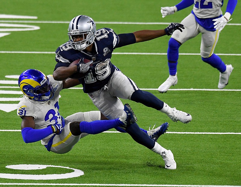 Dallas Cowboys wide receiver Amari Cooper (19) catches a pass over Los Angeles Rams defensive back Darious Williams (31) for a first down in the fourth quarter of an NFL football game, Sunday, Sept. 13, 2020, in Inglewood, Calif. (Keith Birmingham/The Orange County Register via AP)