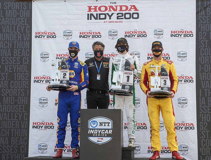 Team owner Michael Andretti (black shirt) stands with his team drivers, race winner Colton Herta (center right) second place finisher Alexander Rossi (left) and third place finisher Ryan Hunter-Reay after the team drivers swept the top three spots at the IndyCar Series race, at Mid-Ohio Sports Car Course in Lexington, Ohio.