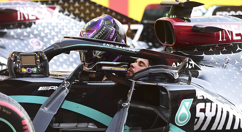 Lewis Hamilton prepares to get out of his car Sunday after winning the Formula One Grand Prix of Tuscany in Scarperia, Italy.