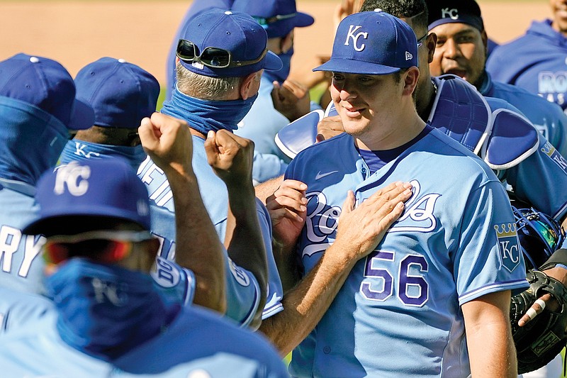 Royals starting pitcher Brad Keller (56) celebrates with his teammates after throwing a complete game Sunday afternoon in an 11-0 win against the Pirates at Kauffman Stadium.