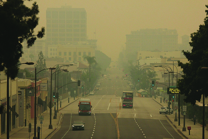 Smoke from wildfires fills the sky Saturday over Pasadena, Calif. The fires consuming the forests of California and Oregon and darkening the skies over San Francisco and Portland are also damaging an economy already struggling with the coronavirus outbreak. 
