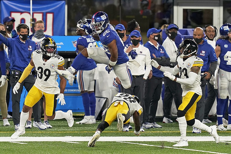 Giants running back Saquon Barkley leaps over Steelers cornerback Mike Hilton during the second quarter of Monday night's game in East Rutherford, N.J.