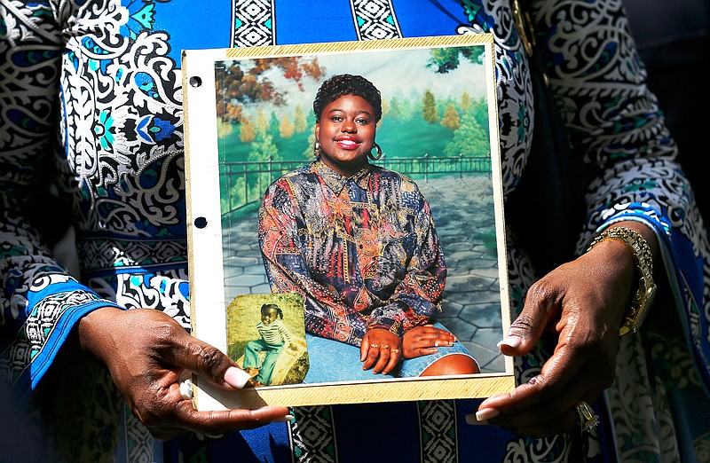 Antoinette Dorsey-James holds a picture of her sister Pamela Turner during a news conference May 16, 2019, outside the Harris County Civil Court in Houston. Baytown Police Officer Juan Delacruz has been charged with assault for fatally shooting Turner in the parking lot of an apartment complex where they both lived in May 2019, prosecutors announced Monday. The two had reportedly struggled over Delacruz's stun gun. (Houston Chronicle via AP)