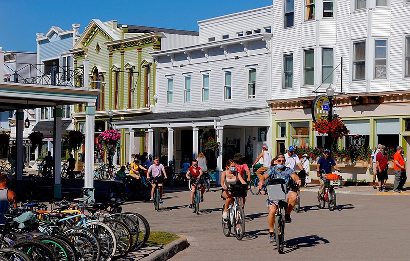 Vacationers walk up and down Main Street in downtown Mackinac Island, Michigan on July 1, 2020. (Eric Seals/Detroit Free Press/TNS)